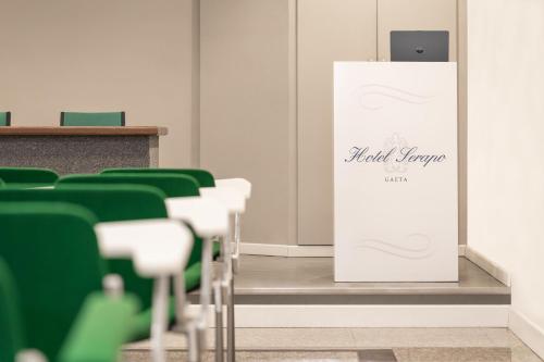 a stand in a conference room with green chairs at Hotel Serapo in Gaeta