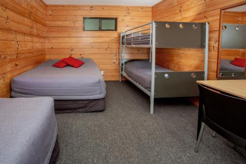 a room with two bunk beds in a cabin at Fox Glacier TOP 10 Holiday Park & Motels in Fox Glacier