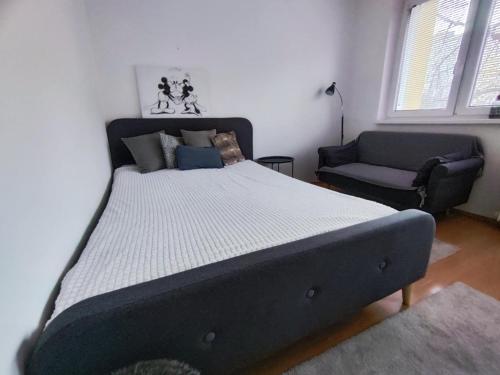 a bed in a room with a couch and a chair at Your Home 7 with parking in Myslava