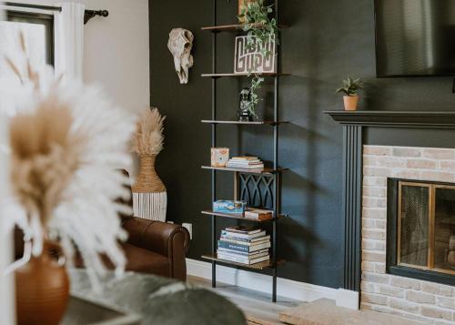 a living room with a fireplace and a book shelf at San Diego Trail Guest Ranch in Poway