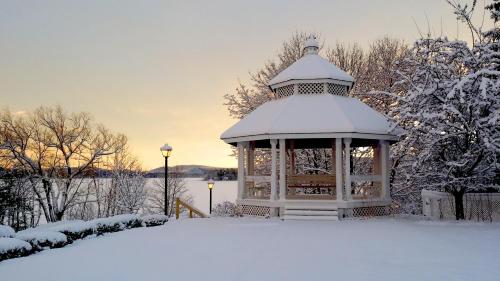 a gazebo covered in snow in a yard at Wolfeboro Inn in Wolfeboro