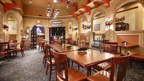 a restaurant with wooden tables and chairs in it at Best Western North Bay Hotel & Conference Centre in North Bay