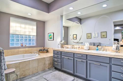 a bathroom with two sinks and a tub and a tubermottermott at Spacious Palm Desert Home with Patio, Pool and Grill in Palm Desert