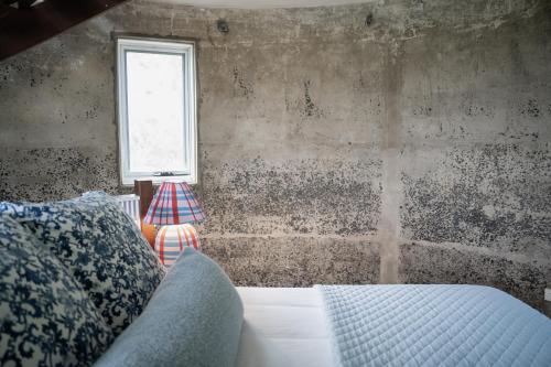 a bedroom with a bed and a window at The Merribee in Numba