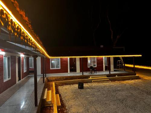 a building with lights on the side of it at night at RedBricks homestay, Coorg in Somvārpet