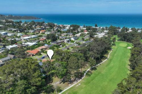 an aerial view of a town with a golf course at Beaches n Birdies in Mollymook