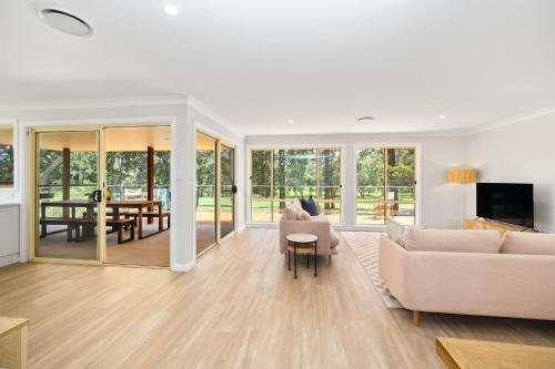 a living room with a couch and a table at Beaches n Birdies in Mollymook