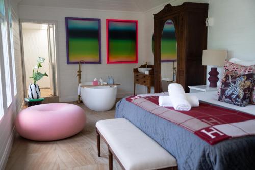 a bedroom with a bed and a tub and a sink at The Merribee in Numba