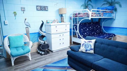 a living room with a blue couch and a bunk bed at Medley Manor in Creve Coeur