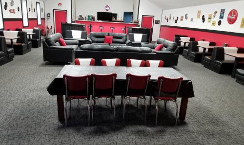 a conference room with a table and chairs and couches at Medley Manor in Creve Coeur