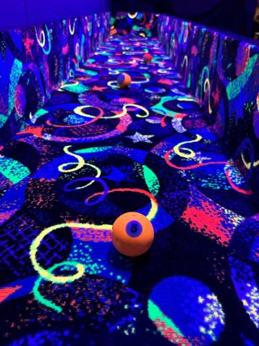 a lit up alley with balls and lights at Medley Manor in Creve Coeur