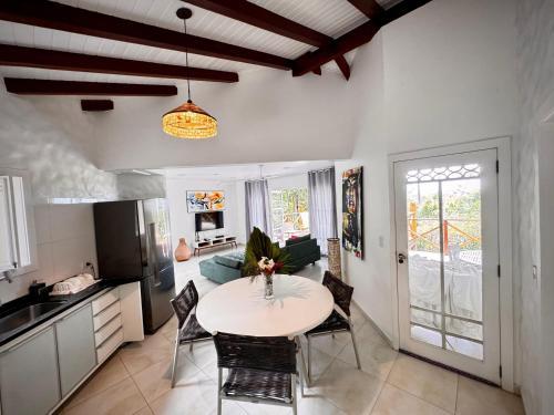 a kitchen and living room with a table and chairs at Sunrise Paradise in Cayru