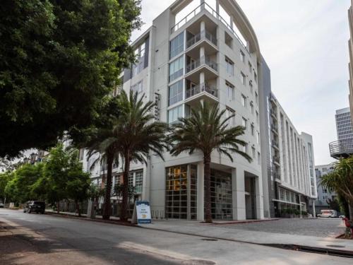 a large white building with palm trees in front of it at West Hollywood 2bdr residence in Los Angeles