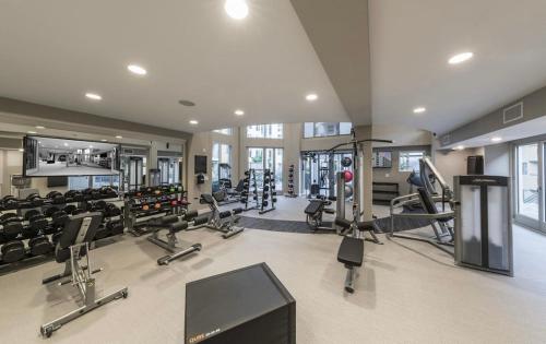 a gym with several treadmills and machines in a room at West Hollywood 2bdr residence in Los Angeles