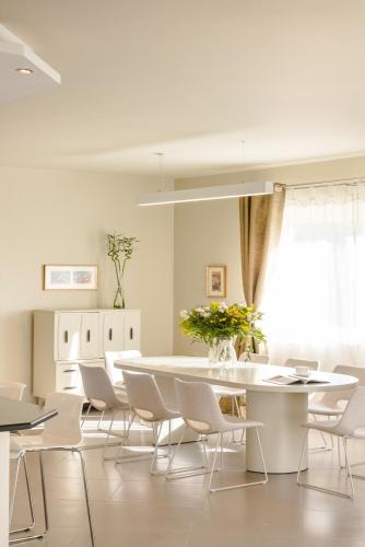 a white dining room with a table and chairs at Villa Felicity in Svoronata