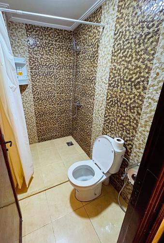 a bathroom with a toilet and a shower at Residence Chay - Luxury Appart in Ouarzazate