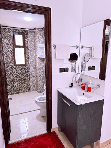 a bathroom with a sink and a toilet and a shower at Residence Chay - Luxury Appart in Ouarzazate