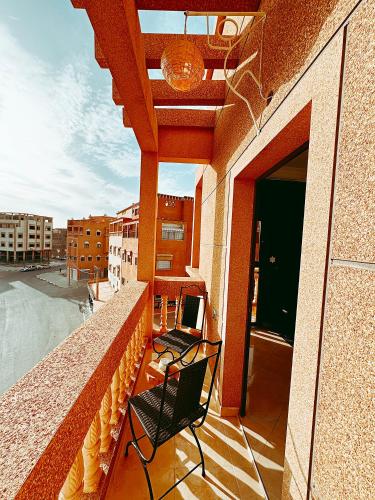 two chairs on the balcony of a building at Residence Chay - Luxury Appart in Ouarzazate