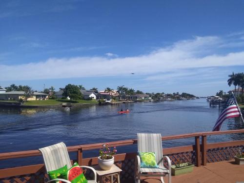 a view of a river from a deck with chairs at Cape Coral Paradise - Spectacular View in Cape Coral