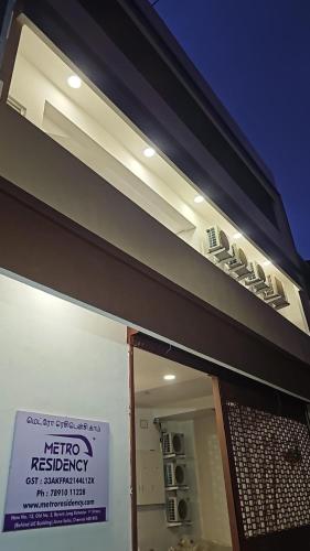 a building with a sign in front of a window at MetroResidency com in Chennai
