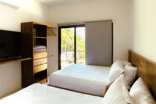 Ένα ή περισσότερα κρεβάτια σε δωμάτιο στο Casa Xchel - Lujo frente a la Bahía piscina jacuzzi y deck