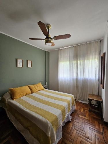 a bedroom with a bed and a ceiling fan at Moreno home in La Plata