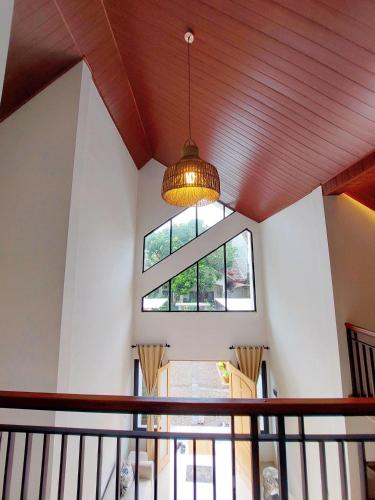 a ceiling with a large window and a light fixture at Yustien Homestay Jogja 3 Bedroom - Private Villa in Bantul