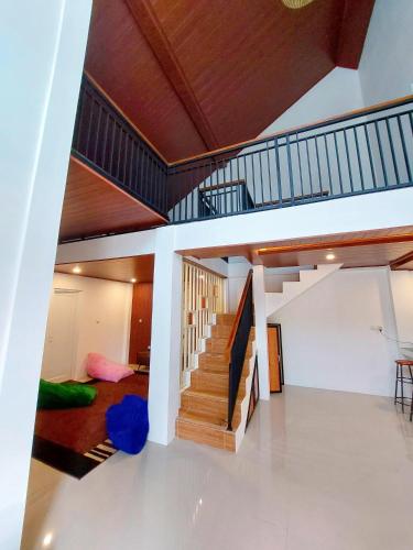 a living room with a staircase in a house at Yustien Homestay Jogja 3 Bedroom - Private Villa in Bantul