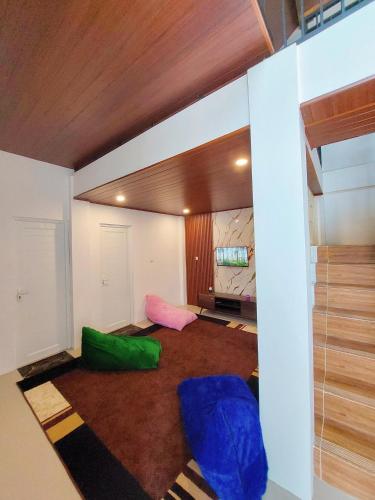 a room with two green and blue chairs in it at Yustien Homestay Jogja 3 Bedroom - Private Villa in Bantul