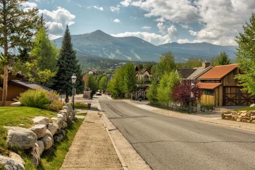 a street in a town with mountains in the background at Rockridge 51 by Summit County Mountain Retreats in Breckenridge