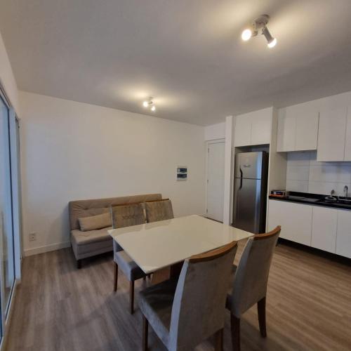 a kitchen and living room with a table and chairs at Excluído por Problemas !! in Campinas