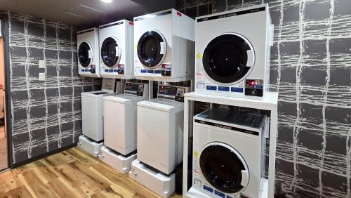 a bunch of washers and dryers in a room at Hotel Route-Inn Dai2 Nagano Naganobekkan in Nagano