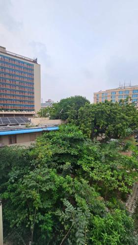 a group of trees in front of a building at MetroResidency com in Chennai