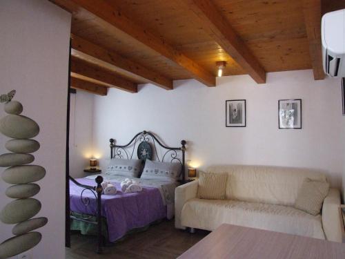 a bedroom with a bed and a couch at Barnaba Edera in Martina Franca