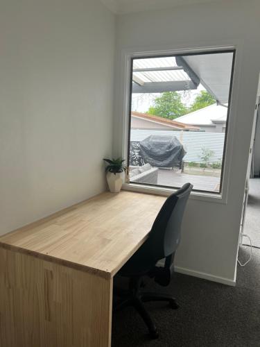 an office with a desk and a chair and a window at Family Home ready for you in Richmond