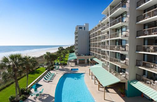 an aerial view of a hotel with a swimming pool and the beach at North Shore Oceanfront Resort Hotel in Myrtle Beach