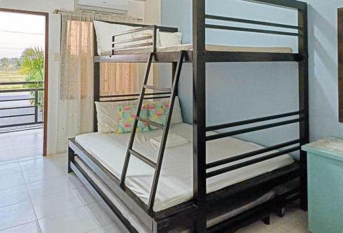 a bedroom with two bunk beds in a room at RedDoorz @ Mary Land Transient Alaminos Pangasinan in Alaminos