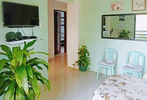 a room with a table and two chairs and a tv at RedDoorz @ Mary Land Transient Alaminos Pangasinan in Alaminos