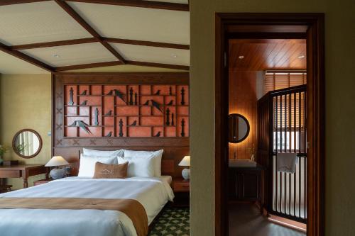 a bedroom with a large bed in a room at The Mist Boutique DaLat Hotel in Da Lat