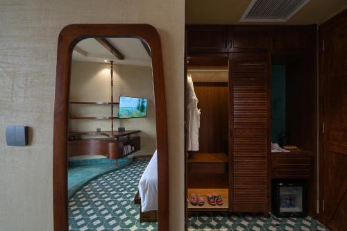a room with a bedroom with a bed and a mirror at The Mist Boutique DaLat Hotel in Da Lat