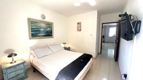 a bedroom with a bed and a television in it at María Hosting 304 in Santa Marta