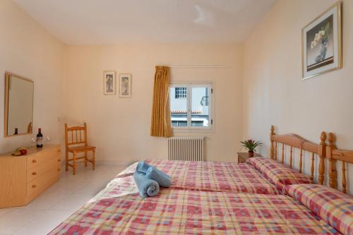 a bedroom with a bed with a stuffed animal on it at Hotel Germán in Vilaflor