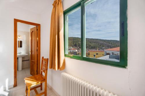 a room with a window and a chair and a radiator at Hotel Germán in Vilaflor