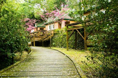 a walkway leading to a house in the woods at Ming Chi Resort in Datong