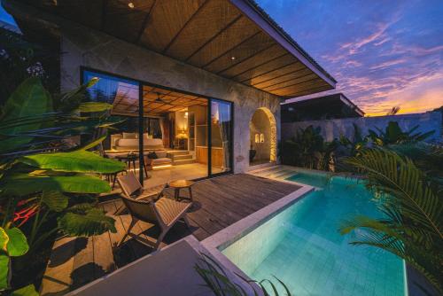 a villa with a swimming pool and a patio at SIVANA, Hotel Boutique with ocean or garden views - Adults only in Uluwatu