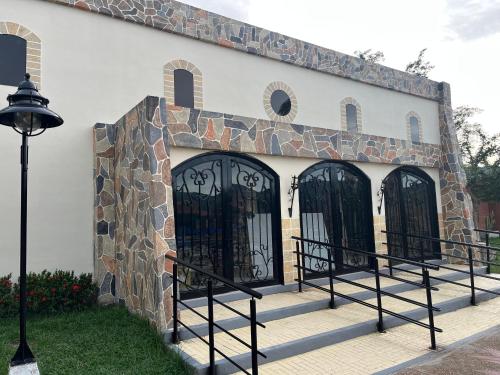 a building with black gates on the side of it at Hotel Los Viñedos in Lemos