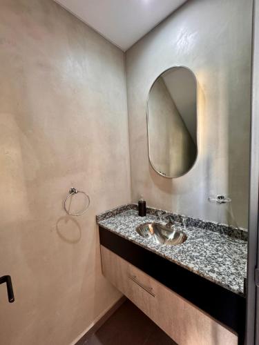 a bathroom with a sink and a mirror at DPTO 405 Edif Loftier in Posadas