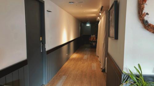 a hallway with wood floors and a long corridor at Chill Roof Hotel in Taipei
