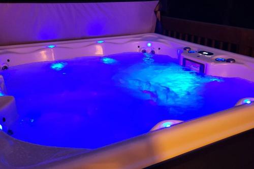 a hot tub with blue lights in a room at Serenity On The Lehigh River in Thornhurst