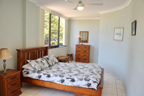 a bedroom with a bed and a window at Paragon Apartment 6 - Bring your own linen. in South West Rocks